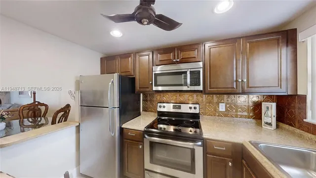 a kitchen with a refrigerator stove and sink