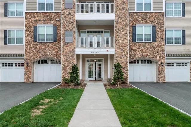 a front view of a house with garden and entryway