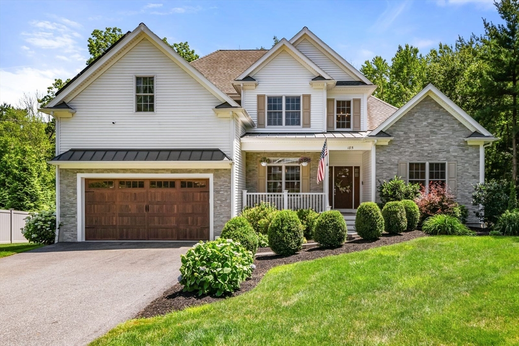 a front view of a house with garden