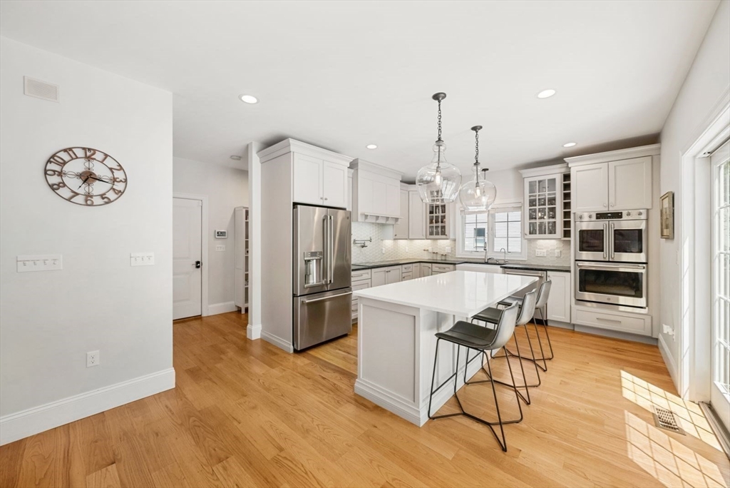 185 Bailey Street Canton, MA 02021 - Photo 11 of 42 a view of a kitchen with refrigerator and wooden floor