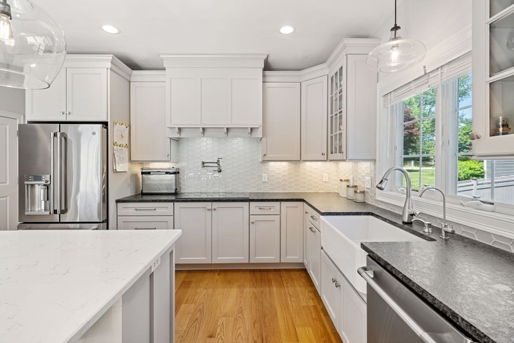 185 Bailey Street Canton, MA 02021 - Photo 13 of 42 a kitchen with stainless steel appliances granite countertop a sink stove and refrigerator