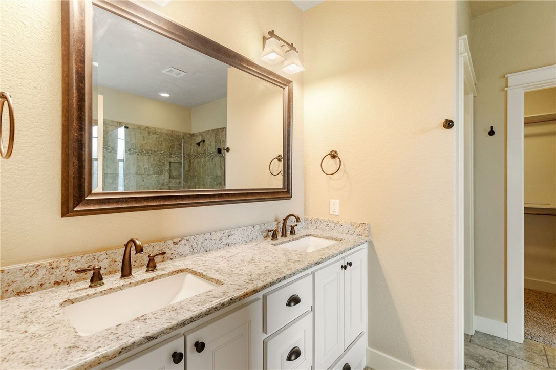 2136 Rockcliffe Loop College Station, TX 77845 - Photo 29 of 48 a bathroom with a granite countertop sink double and a mirror