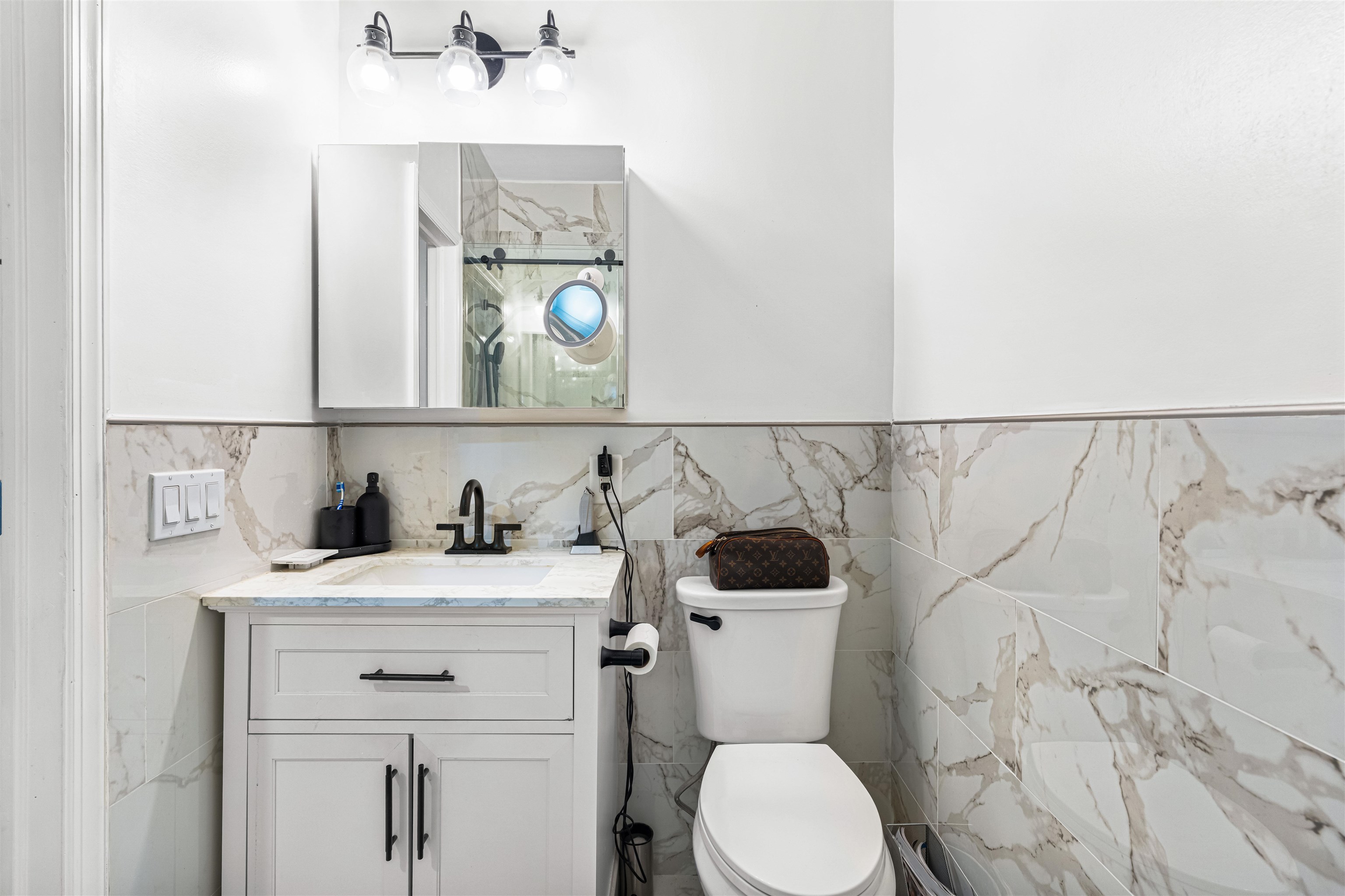193 Halladay Street Jersey City, NJ 07304 - Photo 17 of 49 a bathroom with a sink vanity mirror and toilet