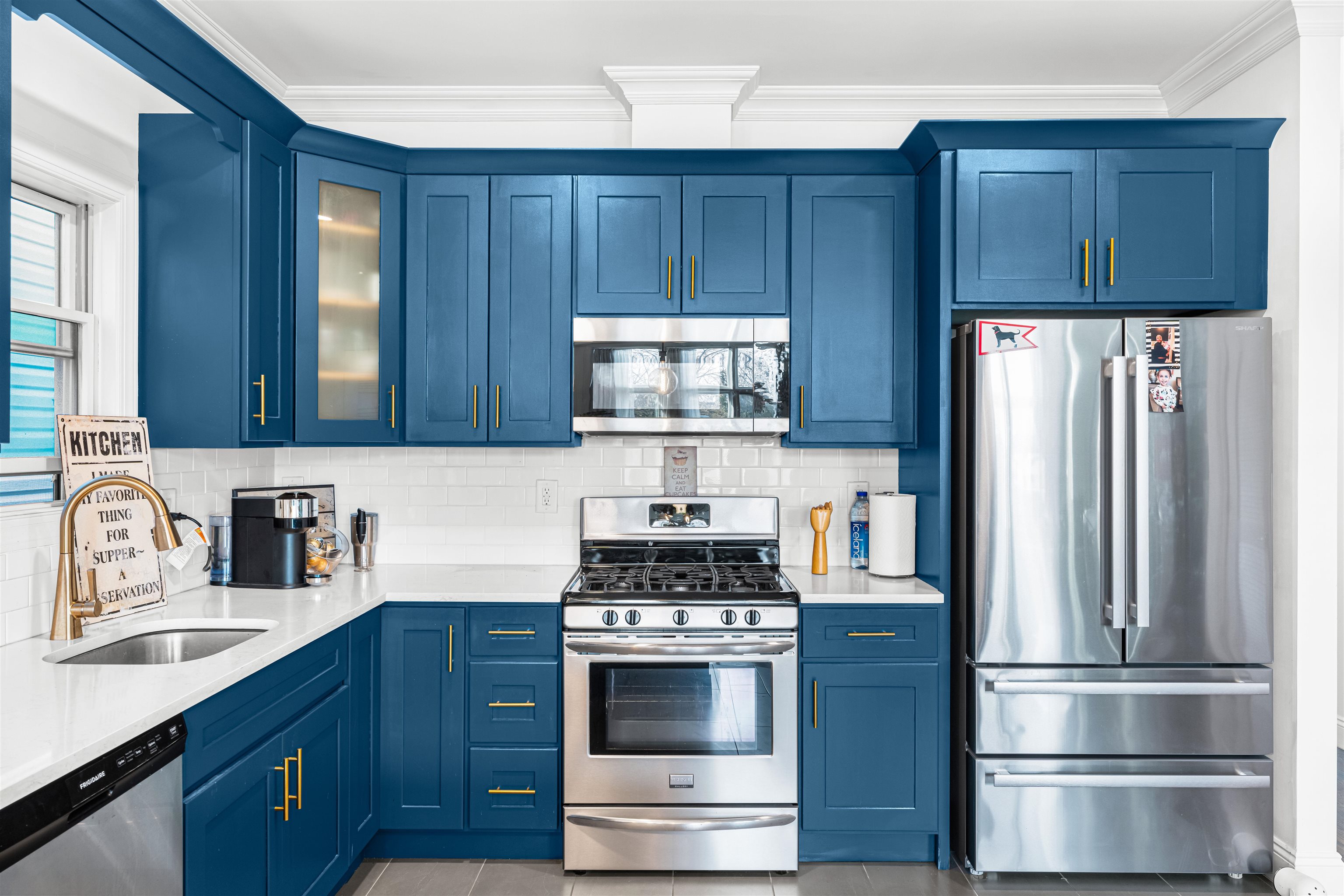 193 Halladay Street Jersey City, NJ 07304 - Photo 9 of 49 a kitchen with stainless steel appliances wooden cabinets and a stove top oven