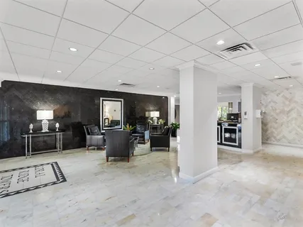a living room with furniture a flat screen tv and a table