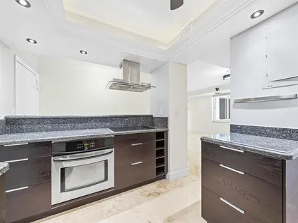 a kitchen with granite countertop a stove and a sink