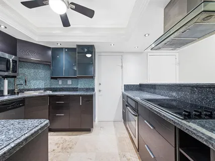 a kitchen with stainless steel appliances granite countertop a sink and stove