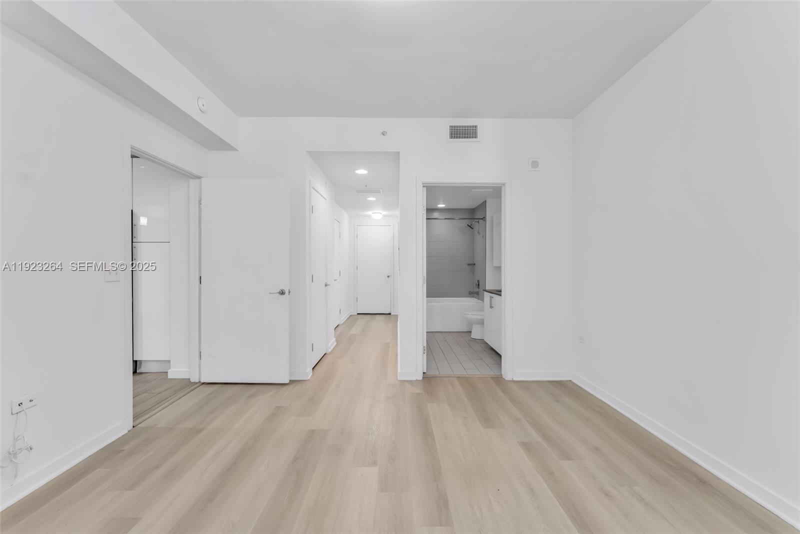 999 Southwest 1st Avenue, Unit 2801 Miami, FL 33130 - Photo 13 of 42 a view of a room with wooden floor