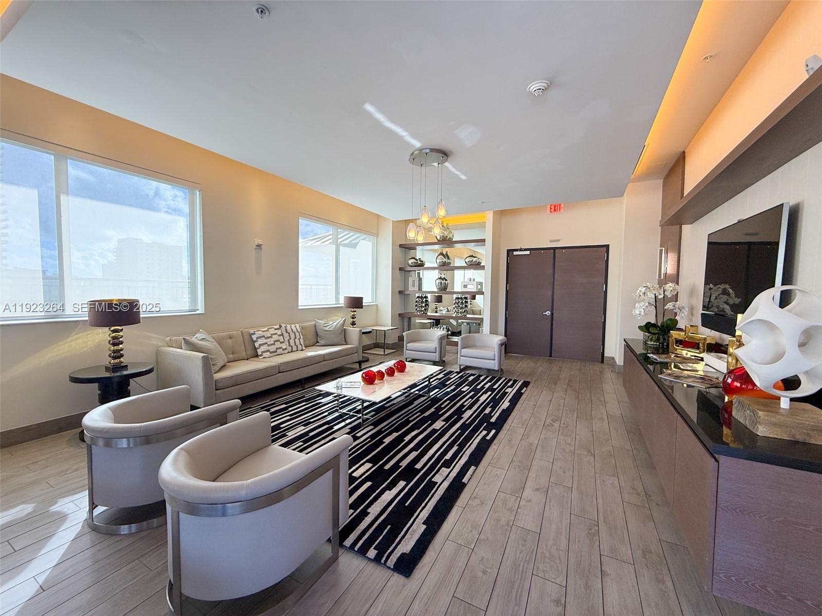 999 Southwest 1st Avenue, Unit 2801 Miami, FL 33130 - Photo 26 of 42 a living room with furniture and a flat screen tv