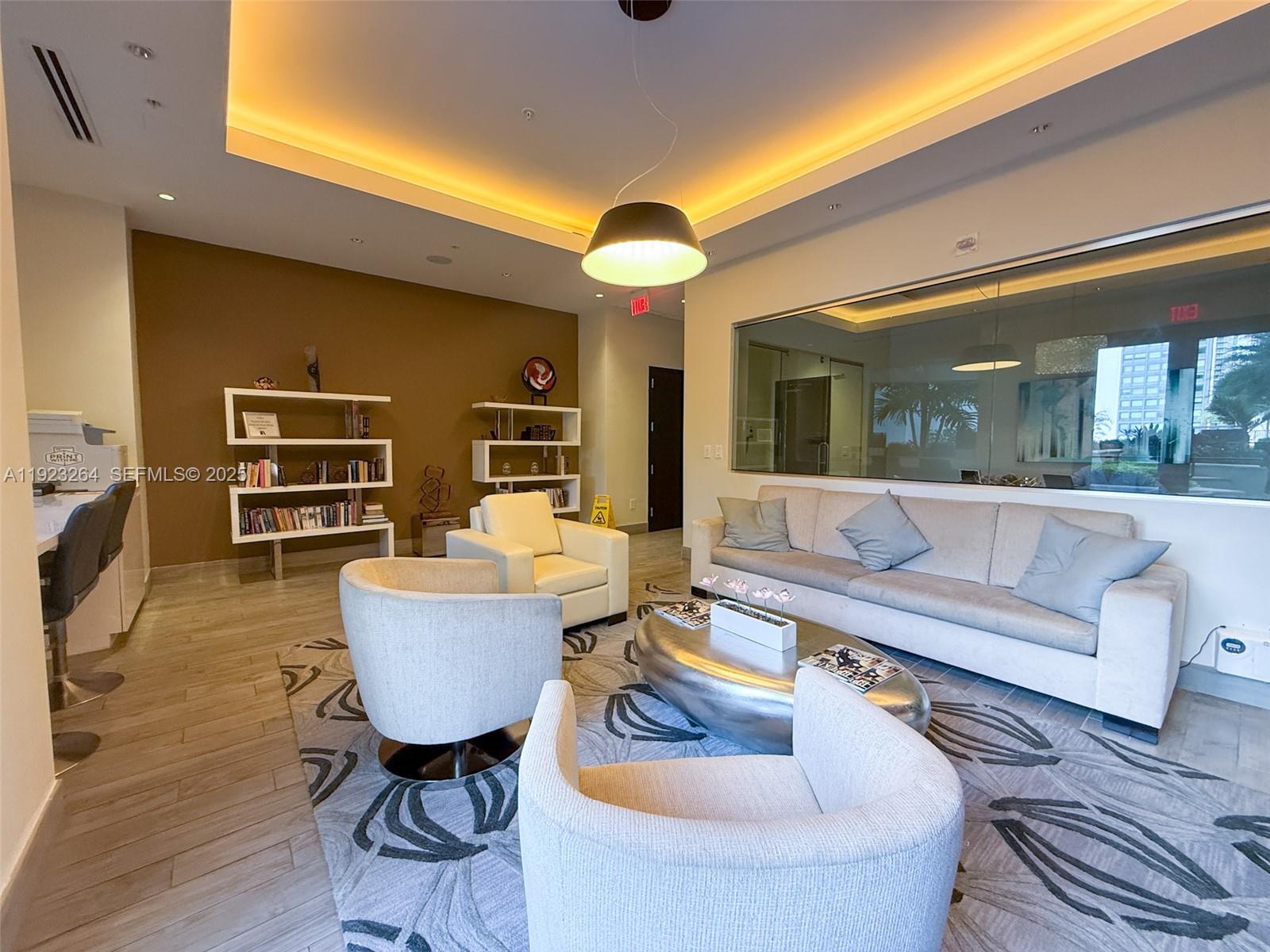 999 Southwest 1st Avenue, Unit 2801 Miami, FL 33130 - Photo 33 of 42 a living room with furniture and a chandelier