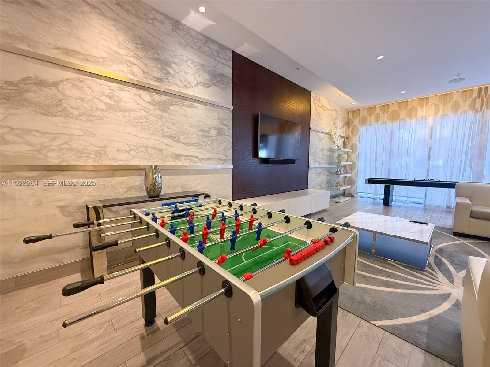999 Southwest 1st Avenue, Unit 2801 Miami, FL 33130 - Photo 35 of 42 a room with furniture and air hockey table