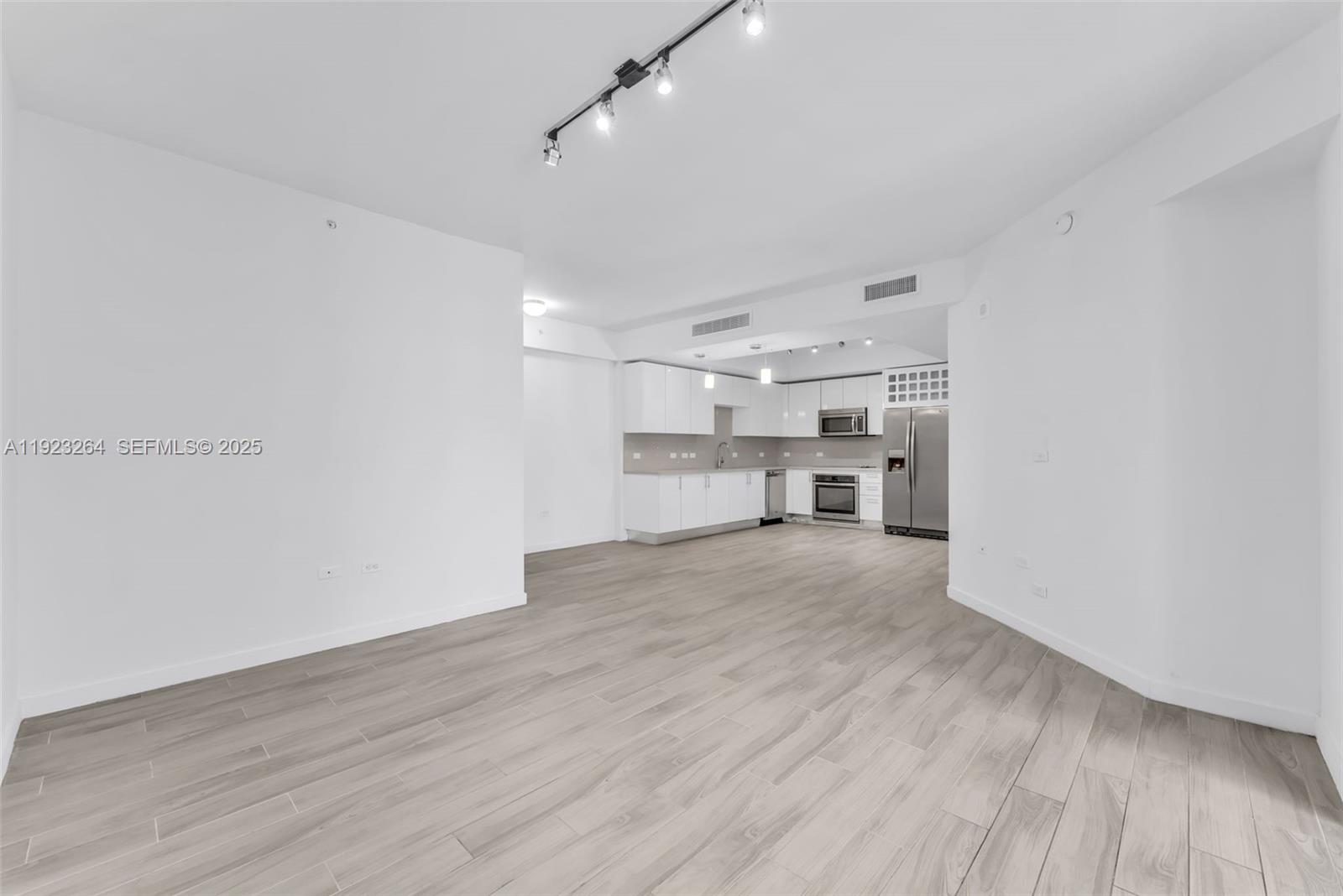 999 Southwest 1st Avenue, Unit 2801 Miami, FL 33130 - Photo 5 of 42 a view of kitchen and wooden floor