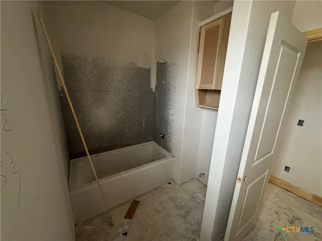 a bathroom with a tub and sink