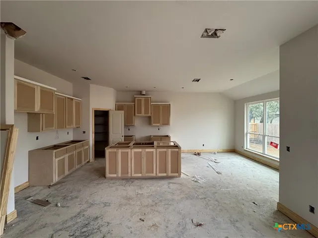 a kitchen with stainless steel appliances a stove a sink and a refrigerator