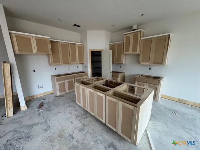 a kitchen that has a sink and a stove