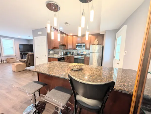 a kitchen with a table chairs and refrigerator