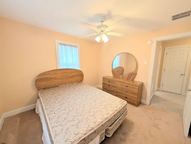 a bedroom with bed and window