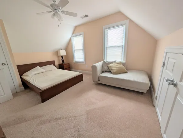 a bedroom with a bed and window