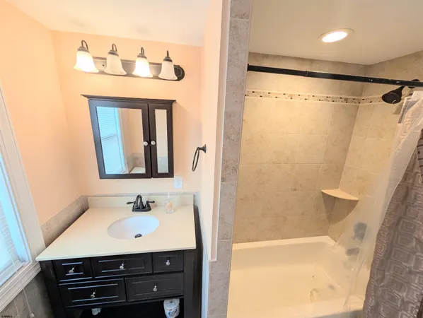 a bathroom with a sink a mirror and a shower