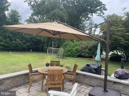 a view of white house with a yard covered in snow