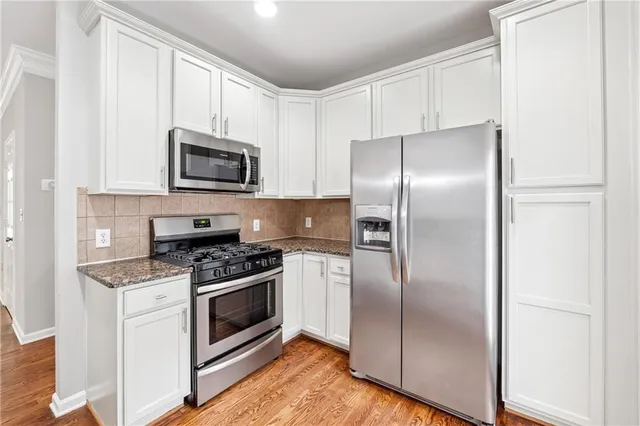 a kitchen with a refrigerator stove and microwave