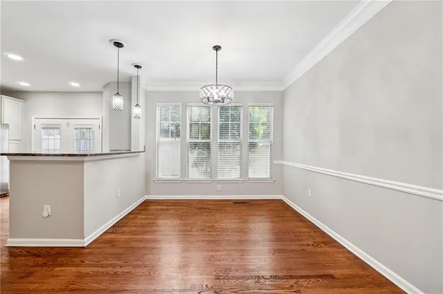 a view of wooden floor and a chandelier in a room