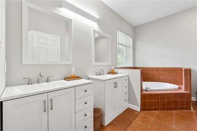 a bathroom with a double vanity sink mirror and