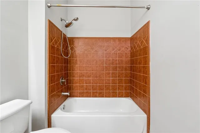 a bathroom with a bathtub and a toilet