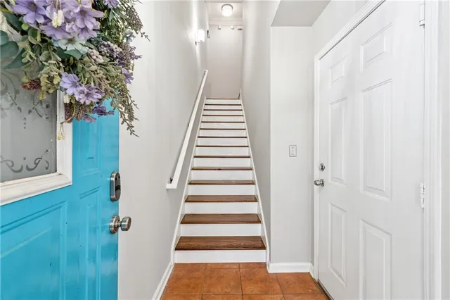 a view of a hallway with wooden floor and stairs