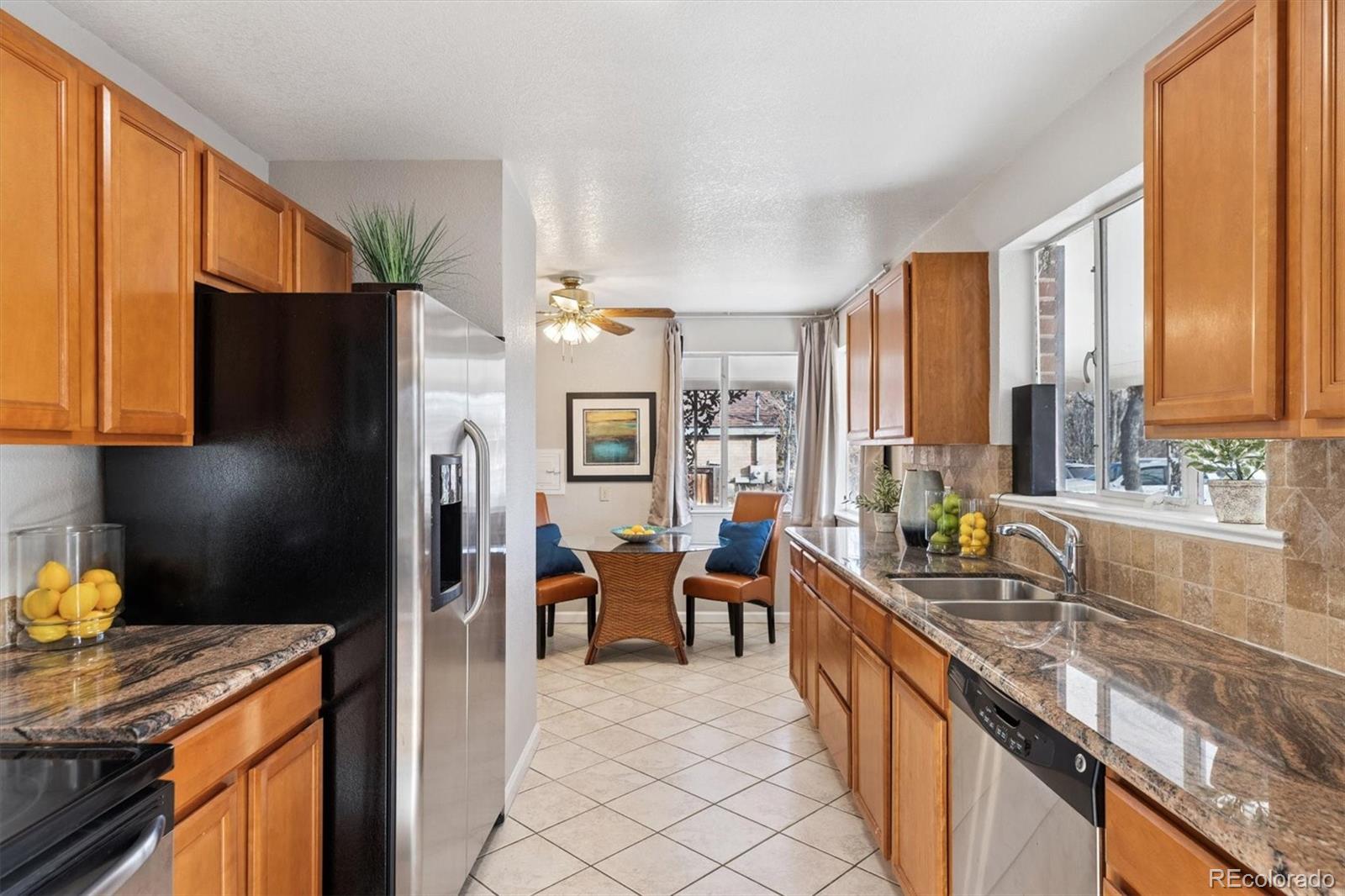 4675 Balsam Street Wheat Ridge, CO 80033 - Photo 9 of 30 a large kitchen with a large window and refrigerator