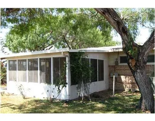 a view of a house with yard and tree s