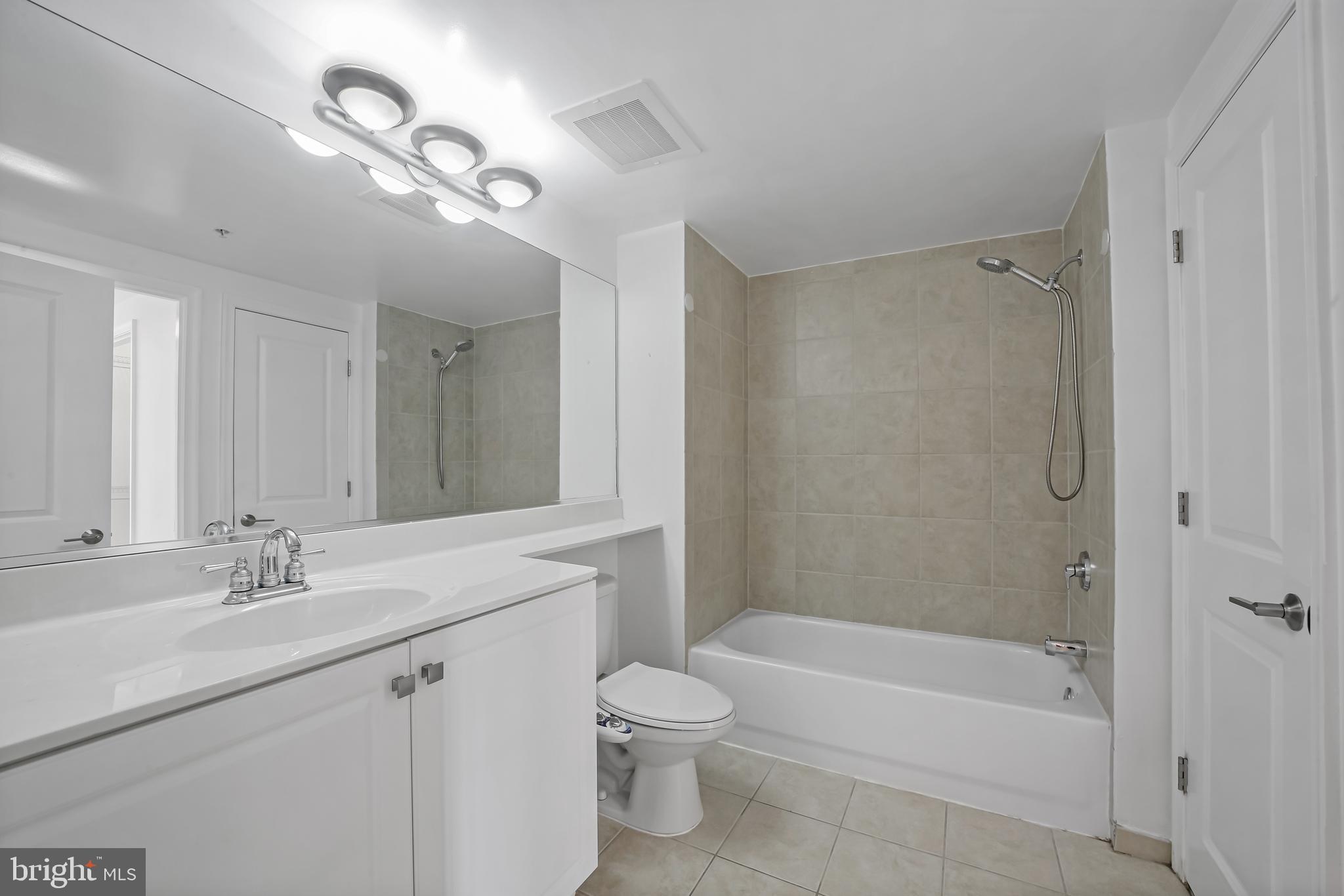 851 North Glebe Road, Unit 1608 Arlington, VA 22203 - Photo 17 of 24 a bathroom with a bathtub shower sink vanity and toilet