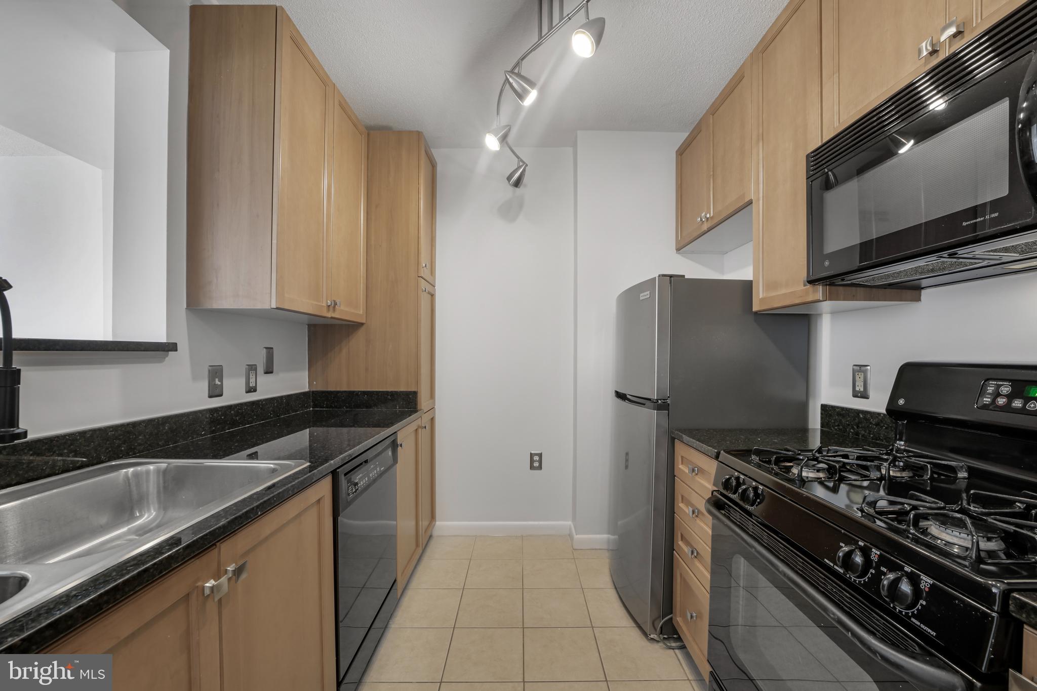 851 North Glebe Road, Unit 1608 Arlington, VA 22203 - Photo 3 of 24 a kitchen with stainless steel appliances granite countertop a sink stove and refrigerator