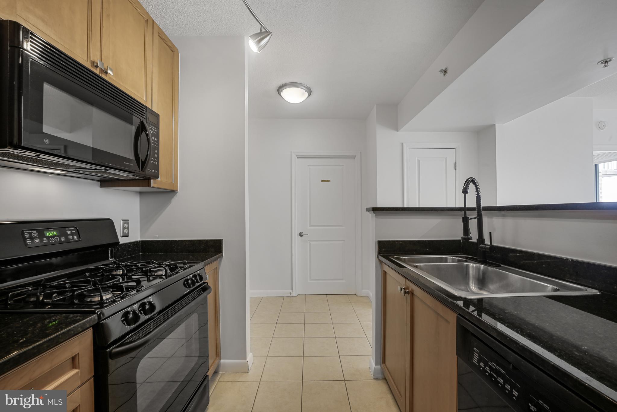 851 North Glebe Road, Unit 1608 Arlington, VA 22203 - Photo 4 of 24 a kitchen that has a sink and a stove