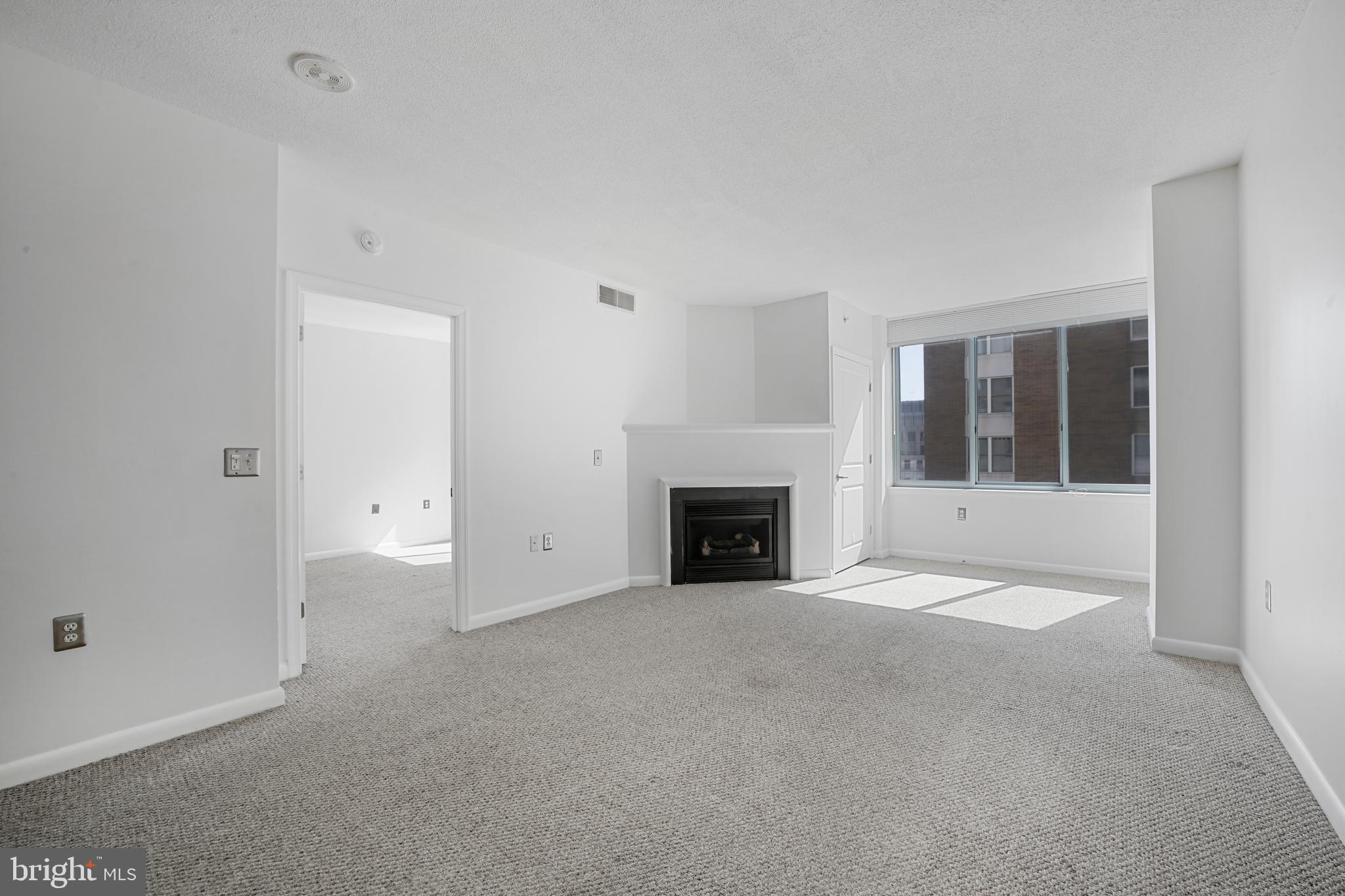 851 North Glebe Road, Unit 1608 Arlington, VA 22203 - Photo 8 of 24 a view of an empty room with a fireplace and a window