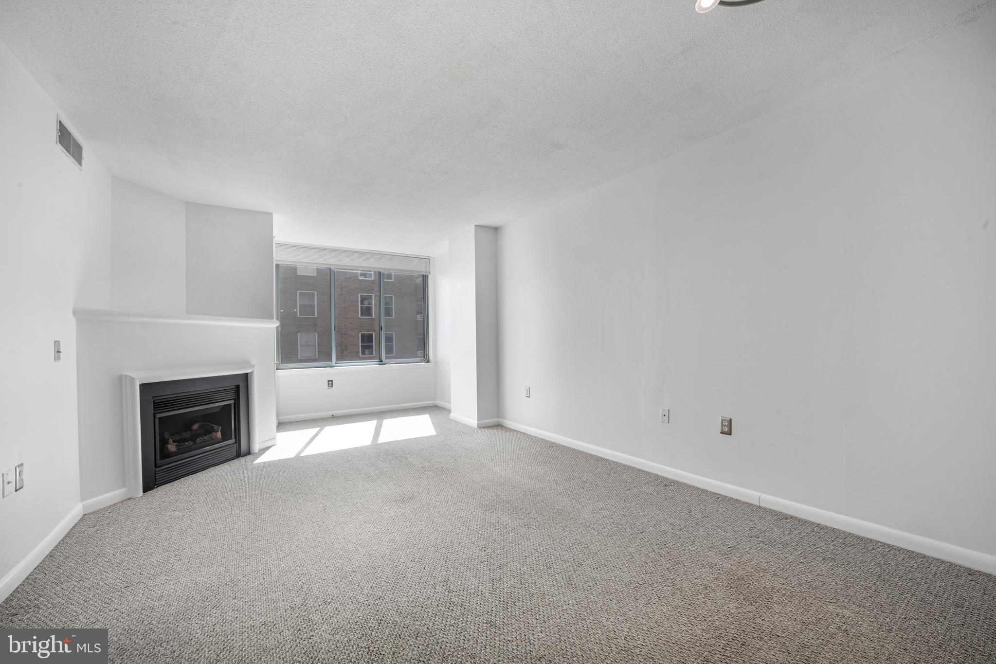 851 North Glebe Road, Unit 1608 Arlington, VA 22203 - Photo 9 of 24 a view of empty room with a fireplace