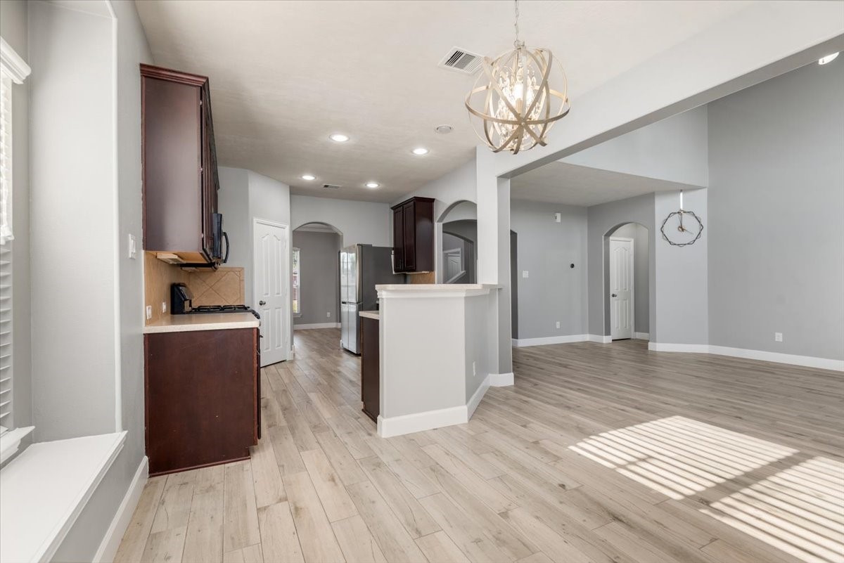 8203 Rudy Brook Way Spring, TX 77379 - Photo 13 of 37 a view of a kitchen with wooden floor and a refrigerator