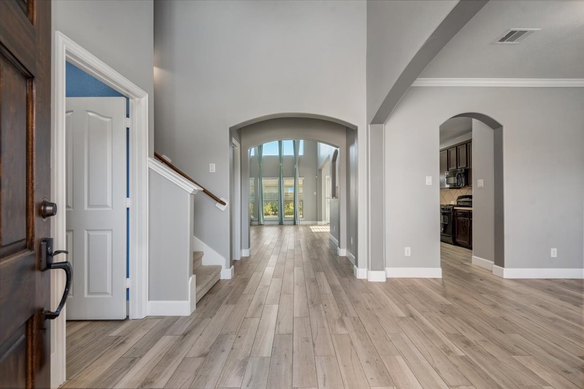 8203 Rudy Brook Way Spring, TX 77379 - Photo 2 of 37 a view of a hallway with wooden floor and stairs