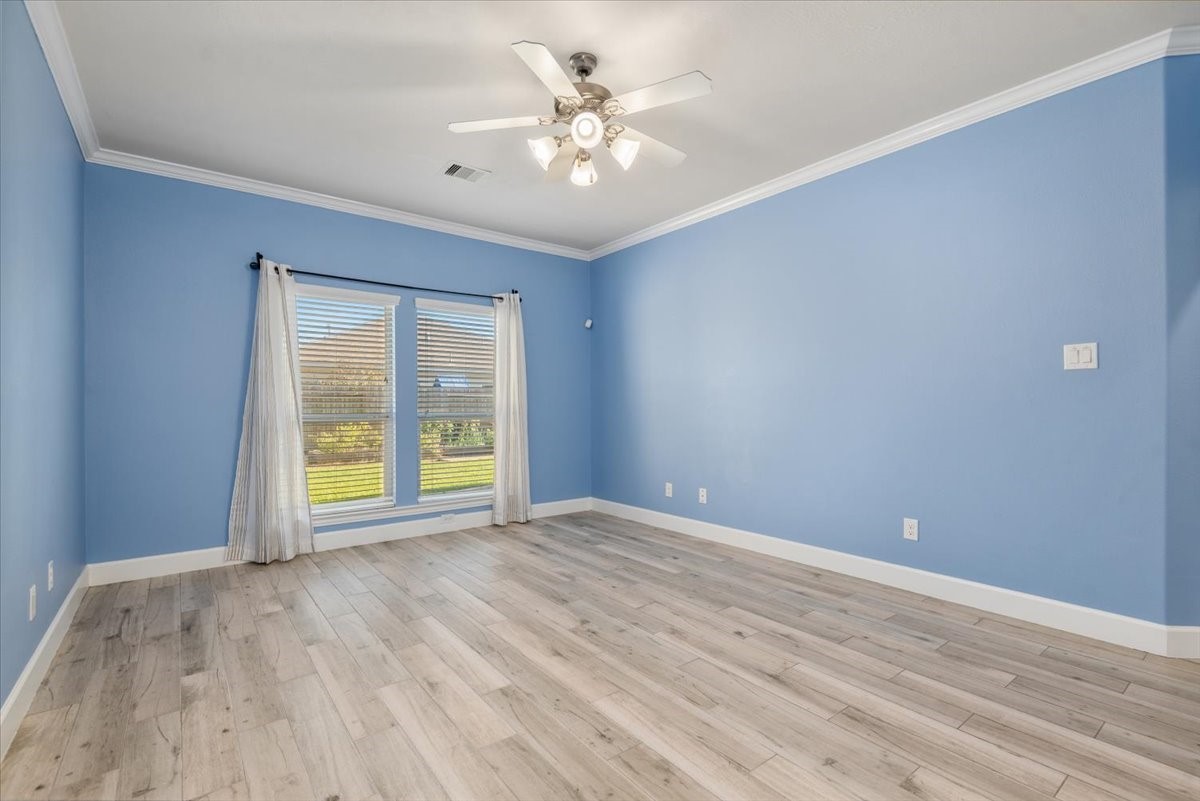 8203 Rudy Brook Way Spring, TX 77379 - Photo 22 of 37 a view of an empty room with a window and a ceiling fan