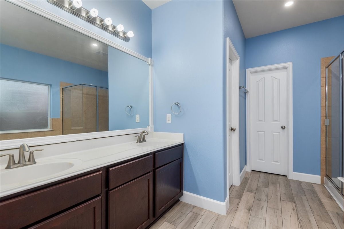 8203 Rudy Brook Way Spring, TX 77379 - Photo 23 of 37 a spacious bathroom with a double vanity sink and a mirror
