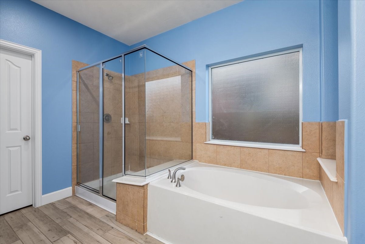 8203 Rudy Brook Way Spring, TX 77379 - Photo 24 of 37 a bathroom with a bathtub and a shower