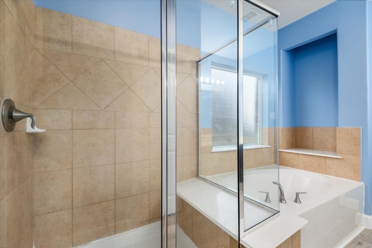 8203 Rudy Brook Way Spring, TX 77379 - Photo 26 of 37 a bathroom with a bathtub and a shower