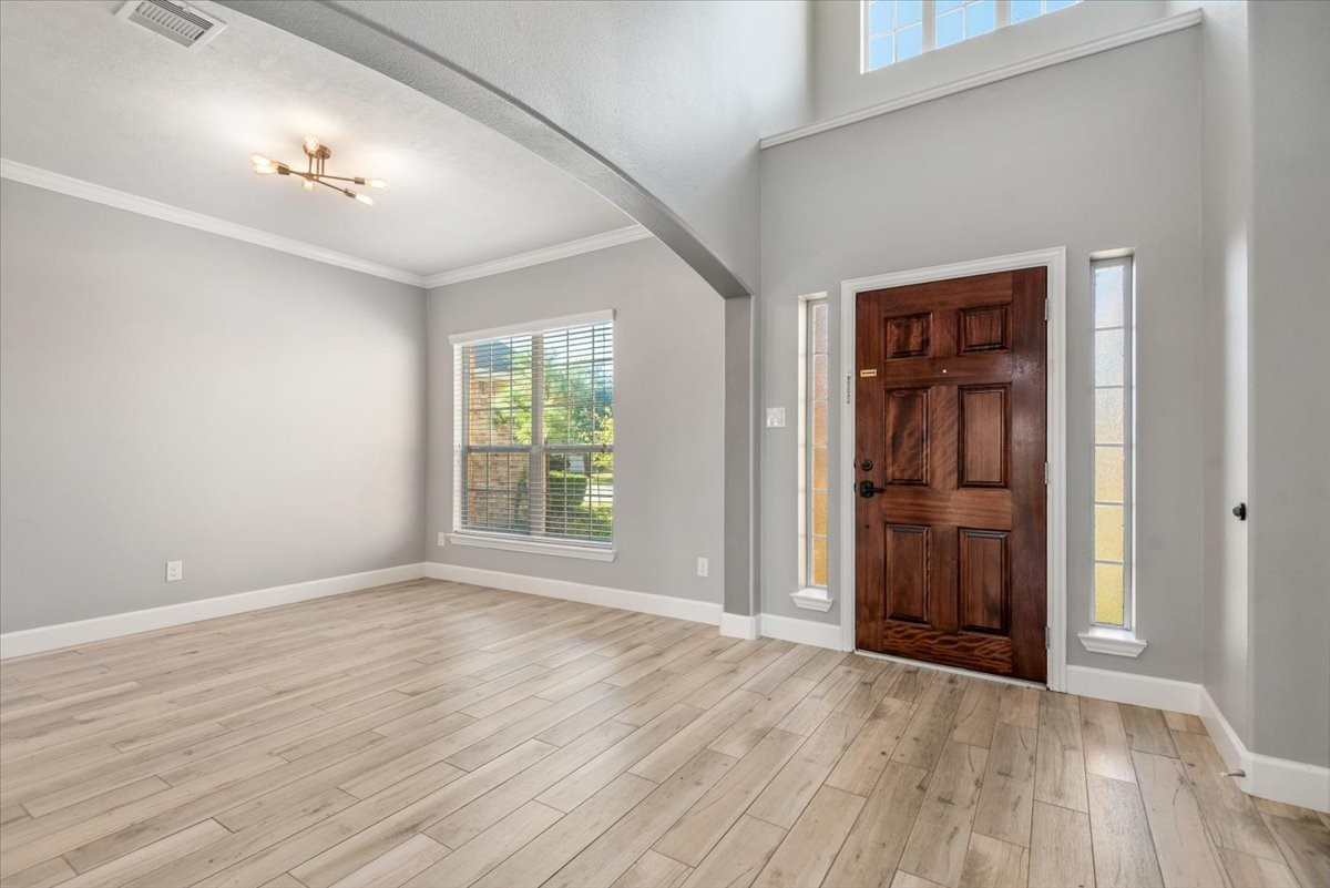 8203 Rudy Brook Way Spring, TX 77379 - Photo 3 of 37 a view of an empty room with wooden floor and a window