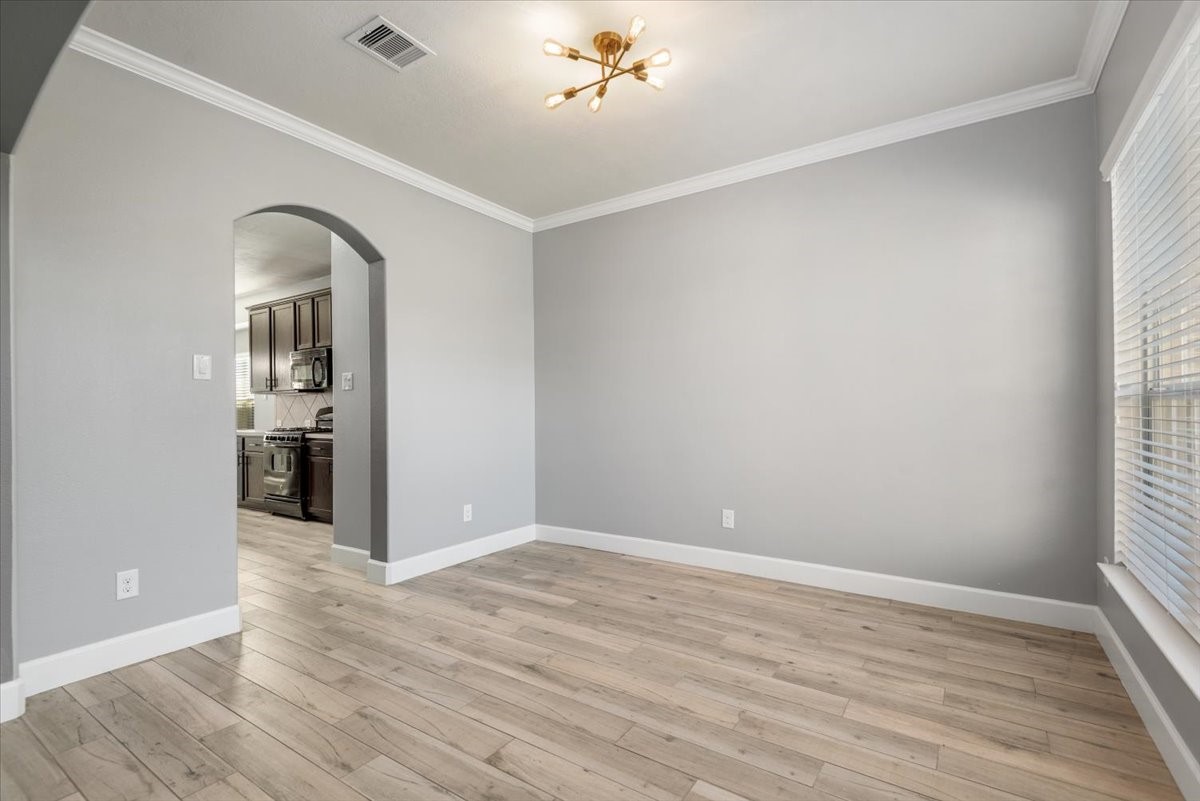 8203 Rudy Brook Way Spring, TX 77379 - Photo 4 of 37 wooden floor in an empty room with a window