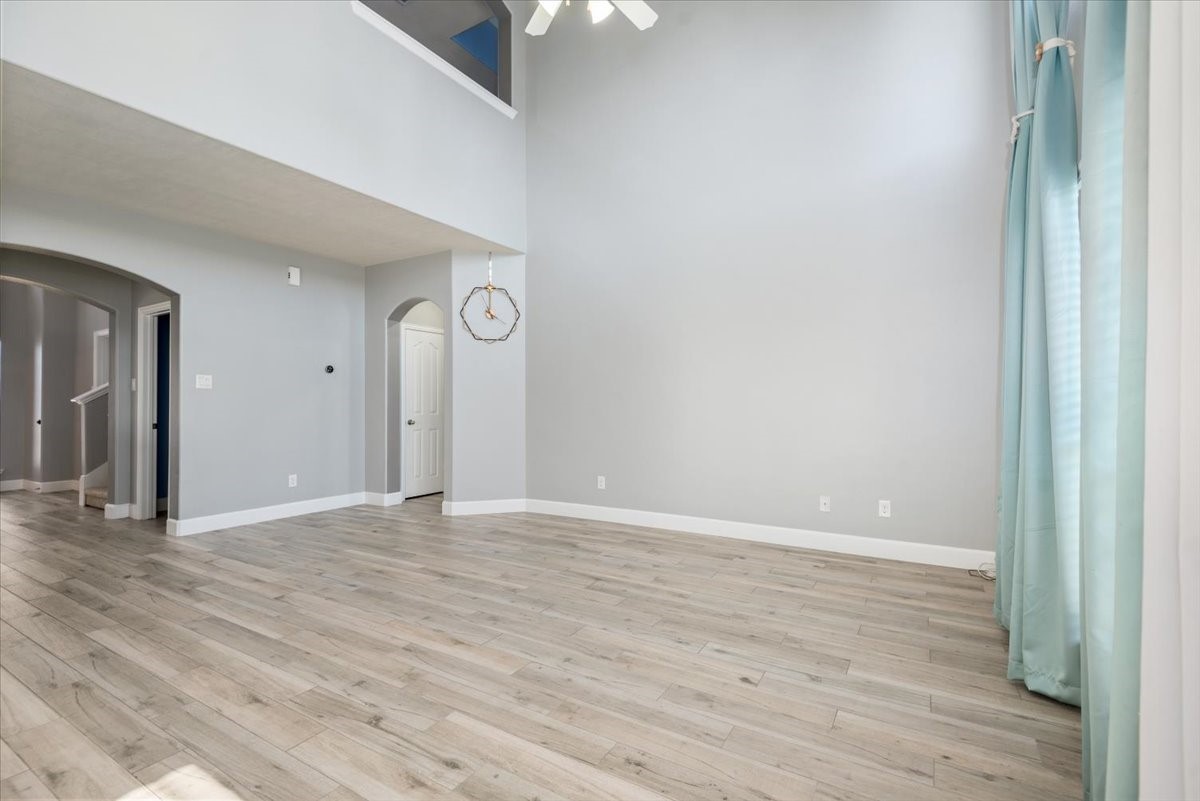 8203 Rudy Brook Way Spring, TX 77379 - Photo 9 of 37 a view of an empty room with wooden floor and a window