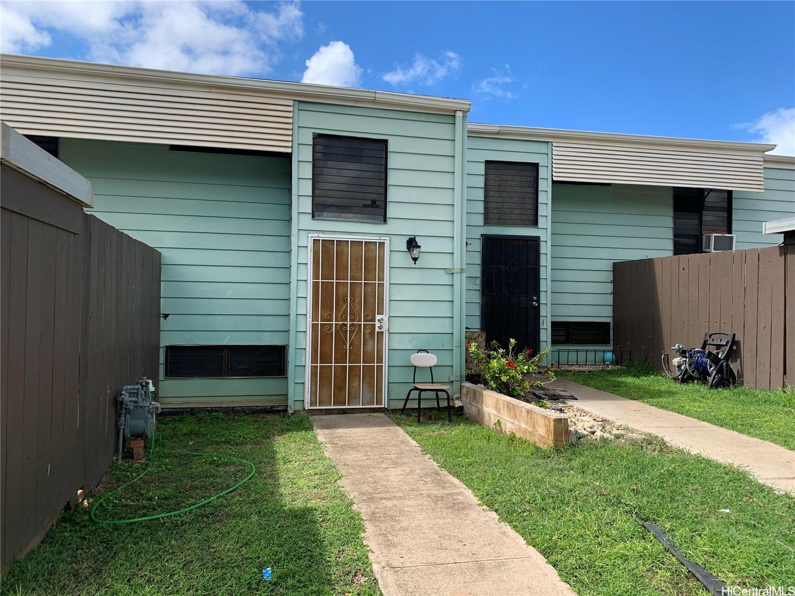 a front view of house with a garden