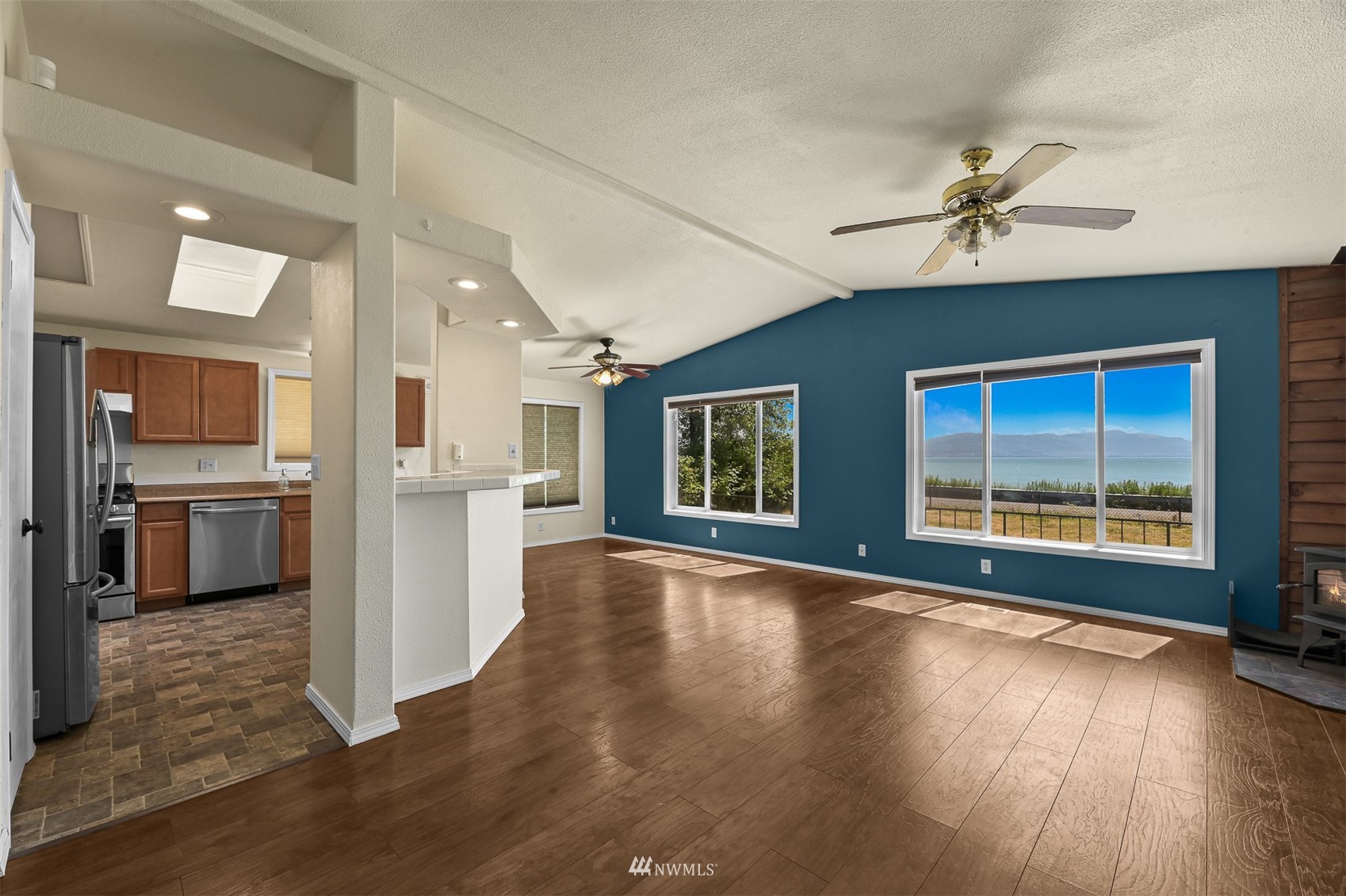 3053 Lummi Shore Road Bellingham, WA 98226 - Photo 11 of 37 a view of a kitchen with a stove cabinets and wooden floor