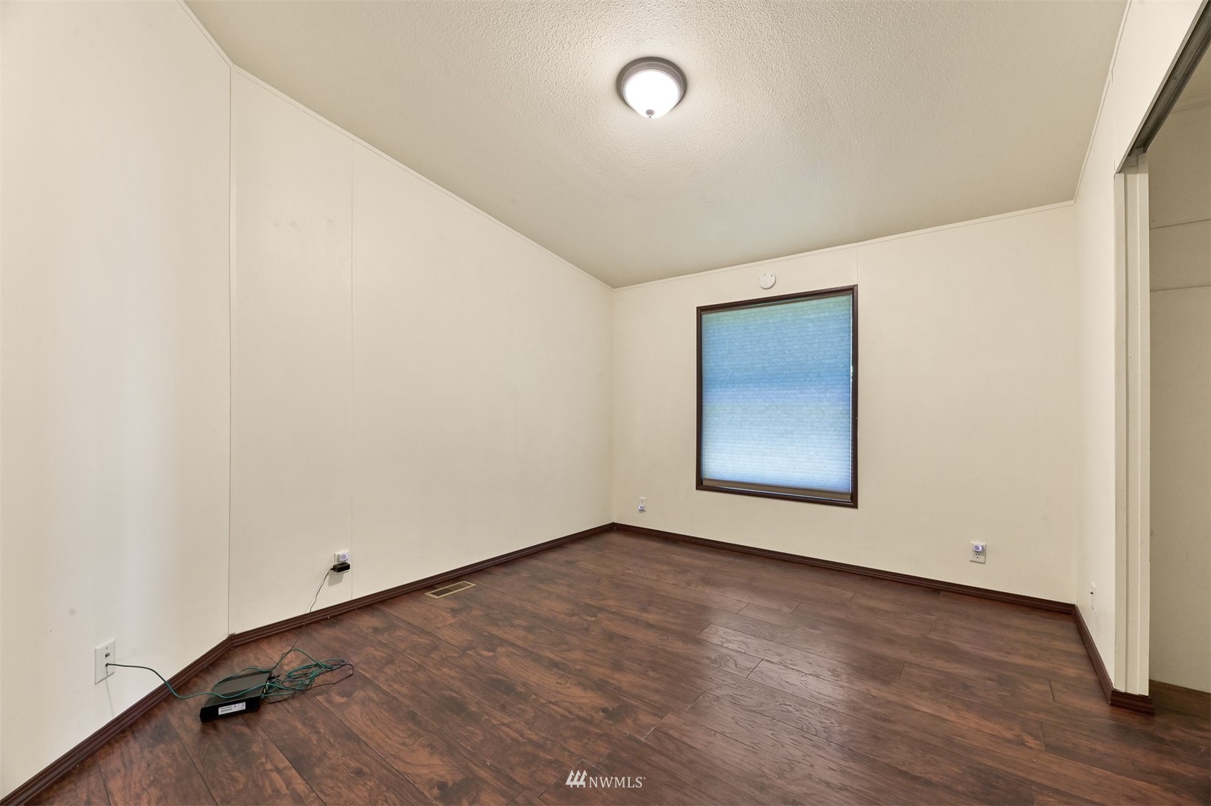 3053 Lummi Shore Road Bellingham, WA 98226 - Photo 26 of 37 an empty room with wooden floor and windows