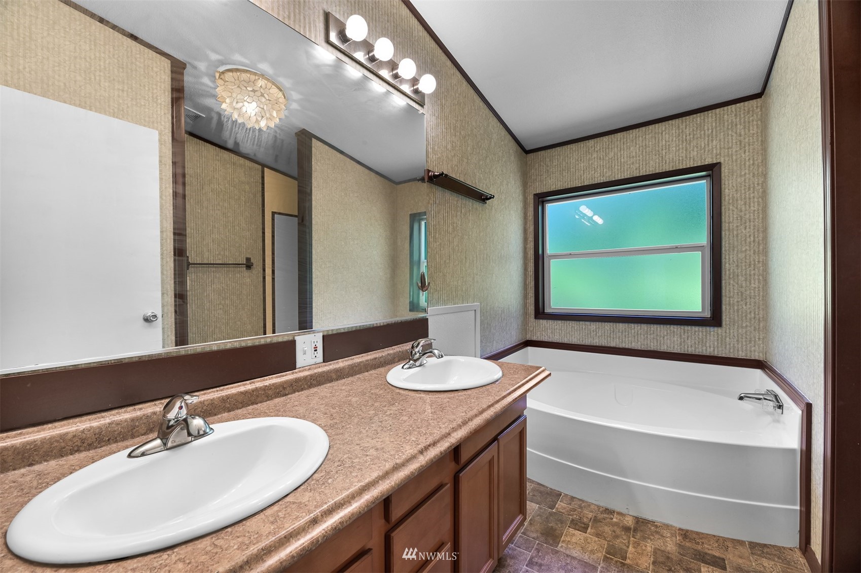 3053 Lummi Shore Road Bellingham, WA 98226 - Photo 29 of 37 a bathroom with a tub double vanity sink and a mirror