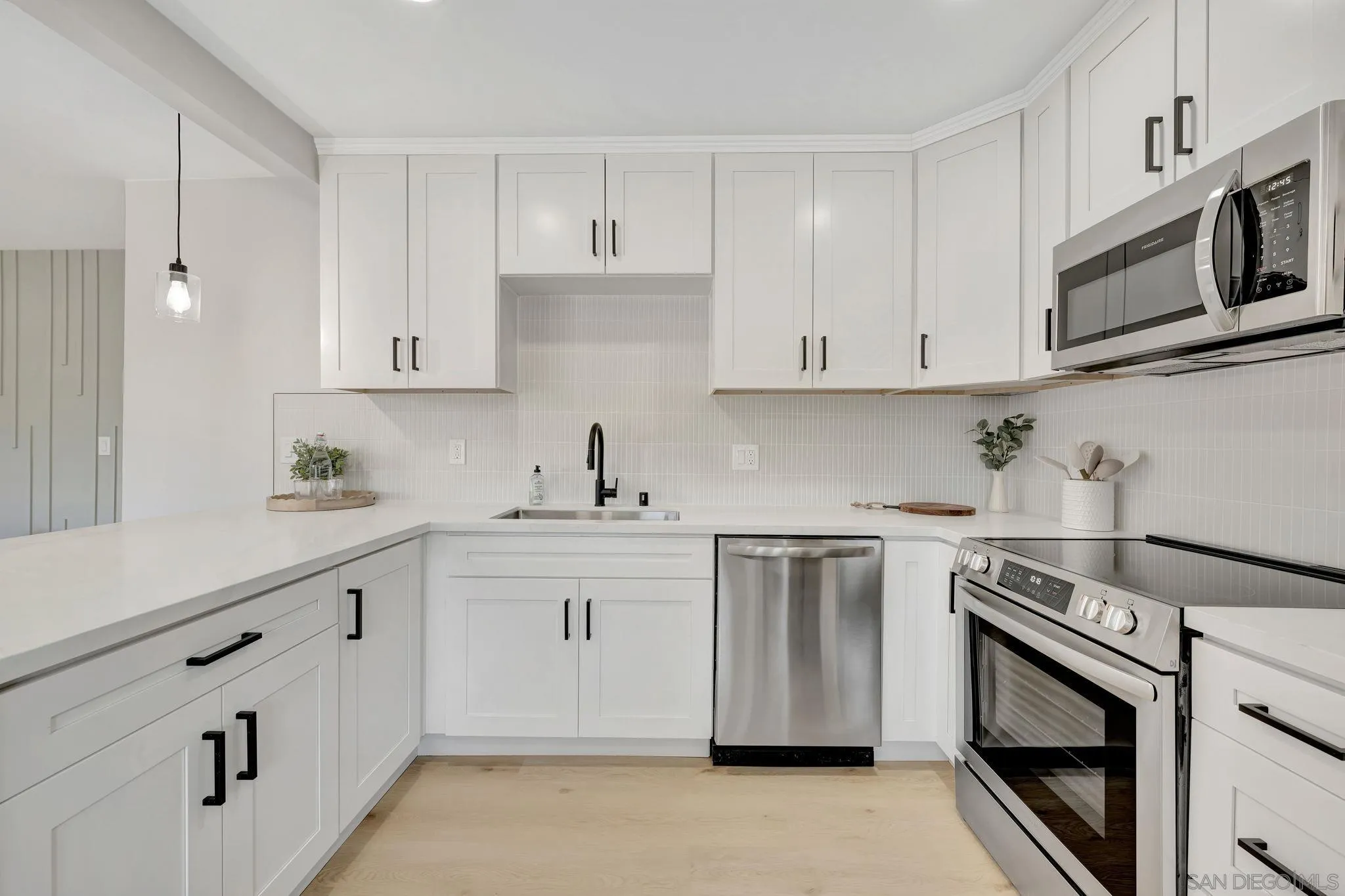 9324 Las Lomas Drive Santee, CA 92071 - Photo 3 of 11 a kitchen with stainless steel appliances granite countertop white cabinets a sink and dishwasher